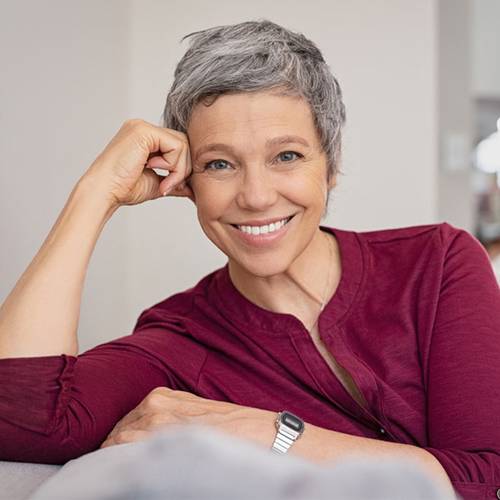 Happy woman showing healthy, confident smile after getting dental implants in Mesa